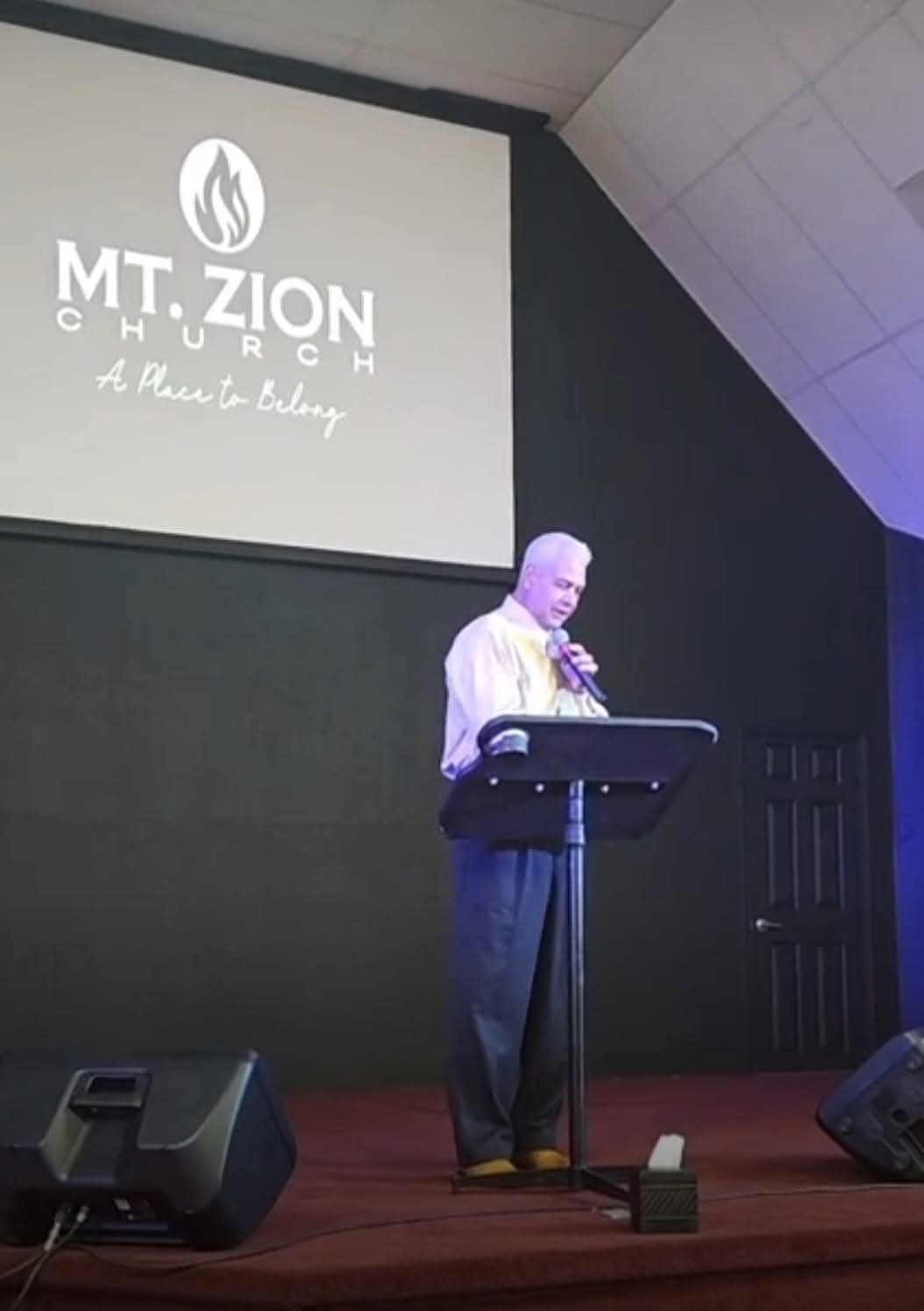 Pastor preaching at the podium at Mt. Zion