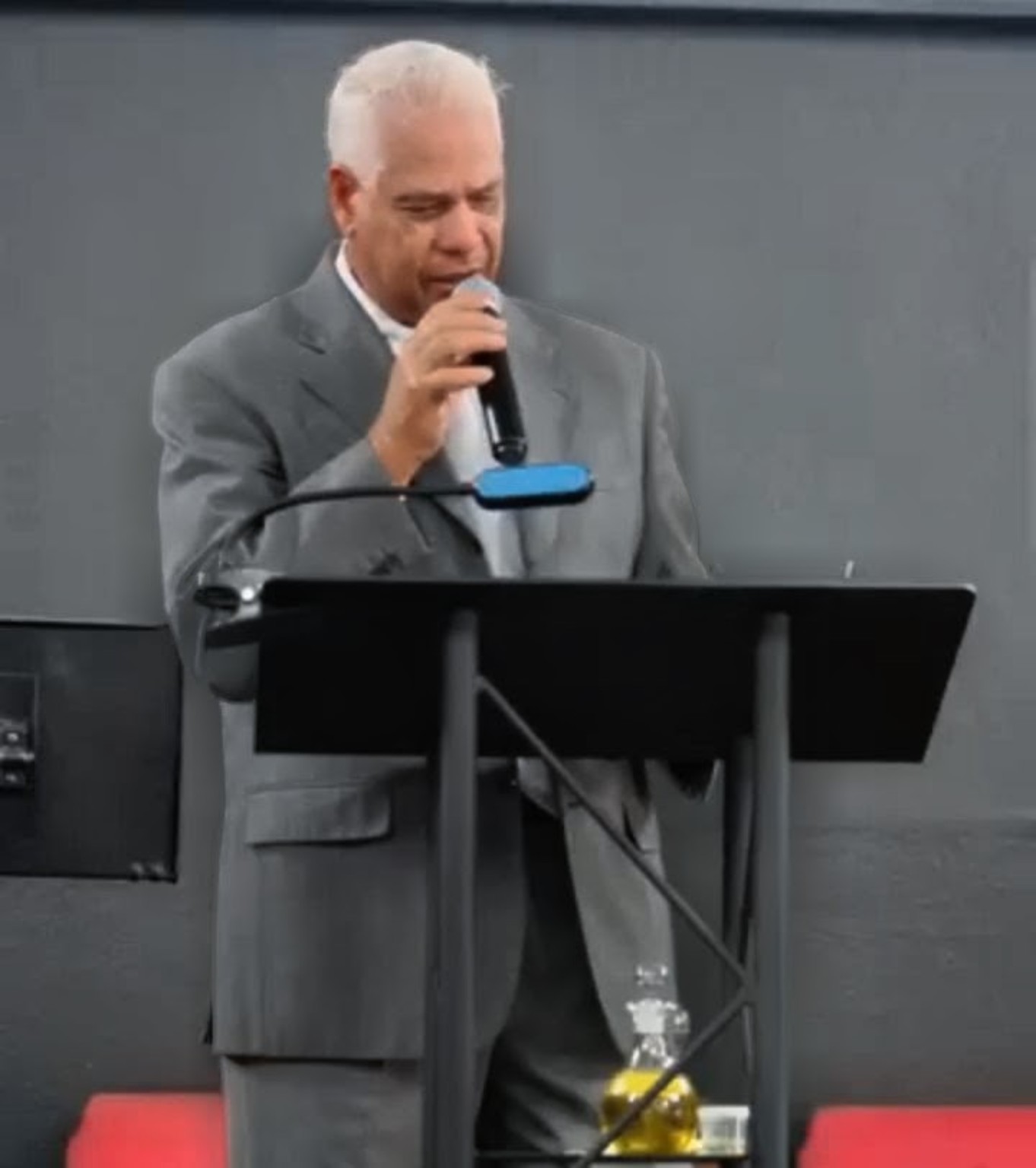 Pastor Jose Alvarado preaching the Word of God from the pulpit